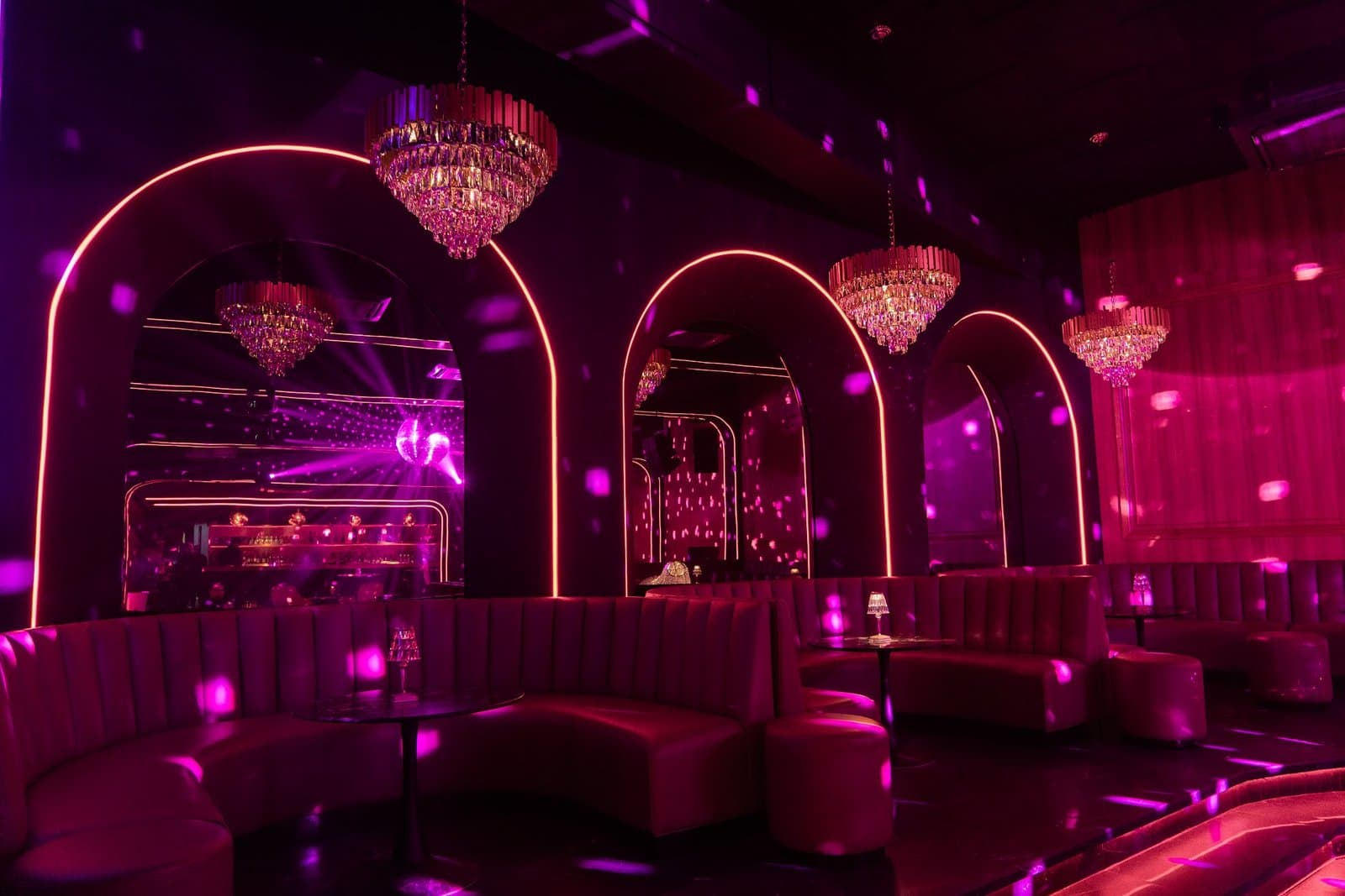Dance floor with a disco ball and pink neon.